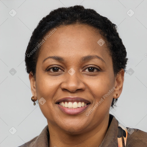 Joyful black young-adult female with short  brown hair and brown eyes