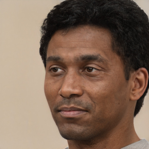 Neutral black adult male with short  black hair and brown eyes
