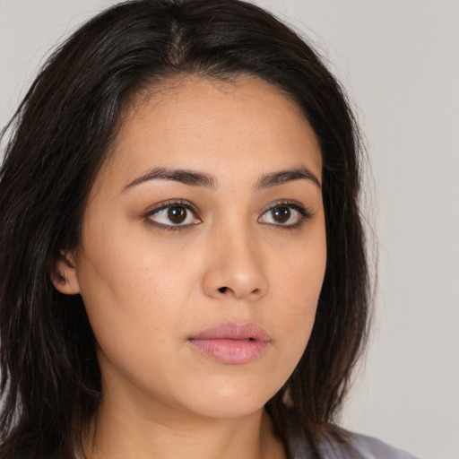 Neutral latino young-adult female with long  brown hair and brown eyes
