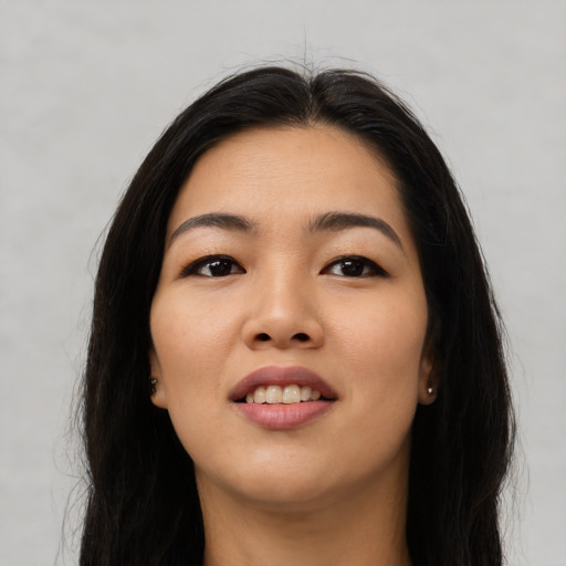 Joyful asian young-adult female with long  black hair and brown eyes