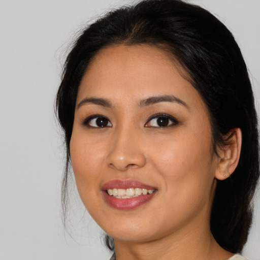 Joyful asian young-adult female with medium  brown hair and brown eyes