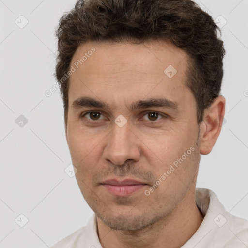 Joyful white adult male with short  brown hair and brown eyes