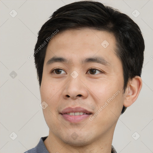 Joyful asian young-adult male with short  black hair and brown eyes