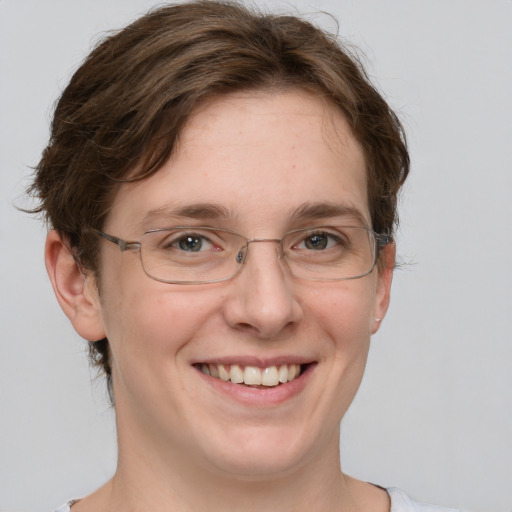 Joyful white adult female with short  brown hair and grey eyes