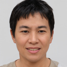 Joyful asian young-adult male with short  brown hair and brown eyes