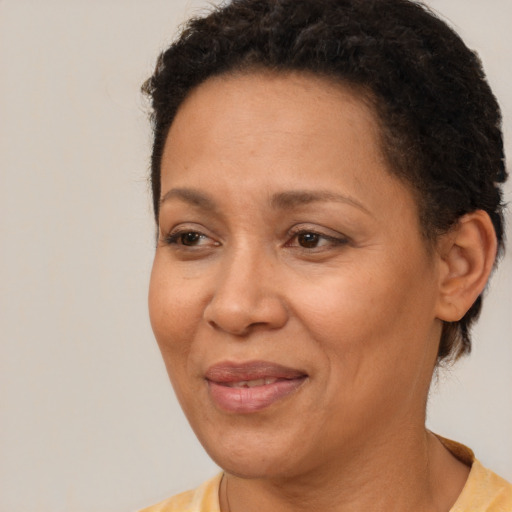 Joyful latino adult female with short  brown hair and brown eyes