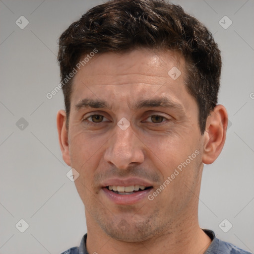 Joyful white adult male with short  brown hair and brown eyes