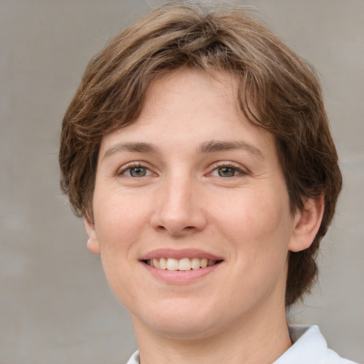 Joyful white young-adult female with medium  brown hair and green eyes