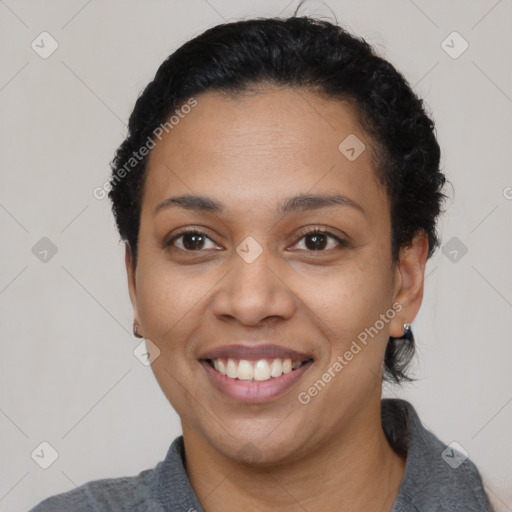 Joyful latino young-adult female with short  black hair and brown eyes