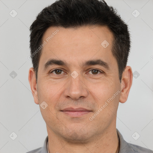 Joyful white adult male with short  black hair and brown eyes