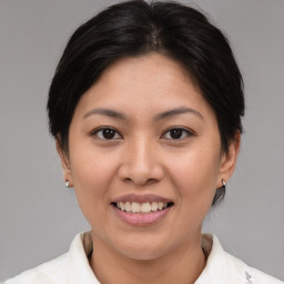 Joyful asian young-adult female with medium  brown hair and brown eyes