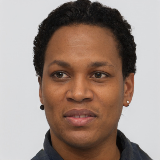 Joyful black adult female with short  black hair and brown eyes