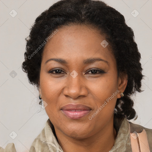 Joyful black adult female with medium  brown hair and brown eyes