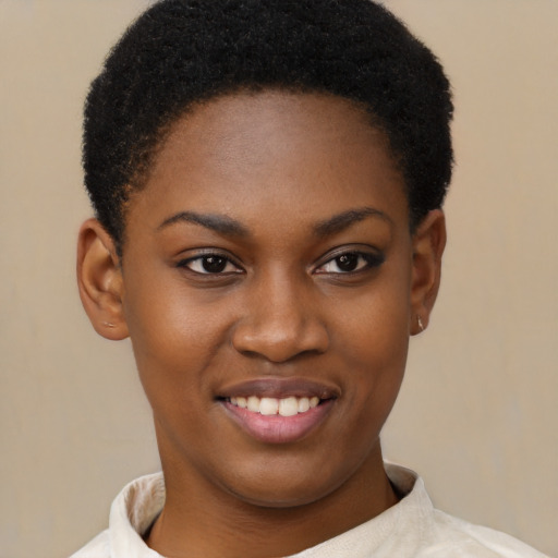 Joyful black young-adult female with short  brown hair and brown eyes