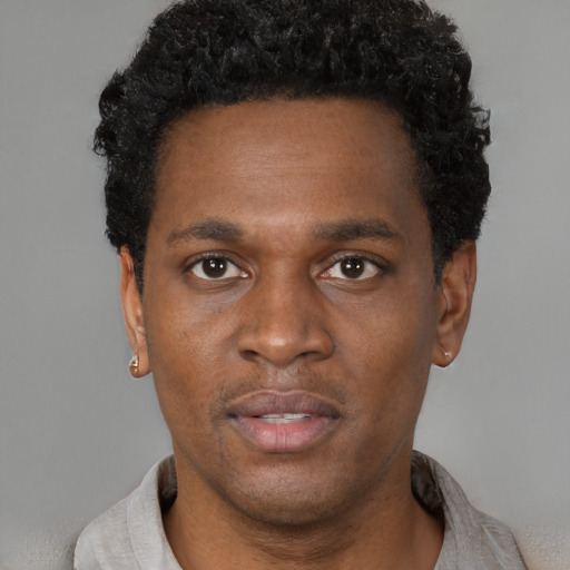 Neutral black young-adult male with short  black hair and brown eyes