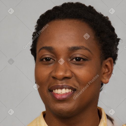 Joyful black young-adult female with short  black hair and brown eyes