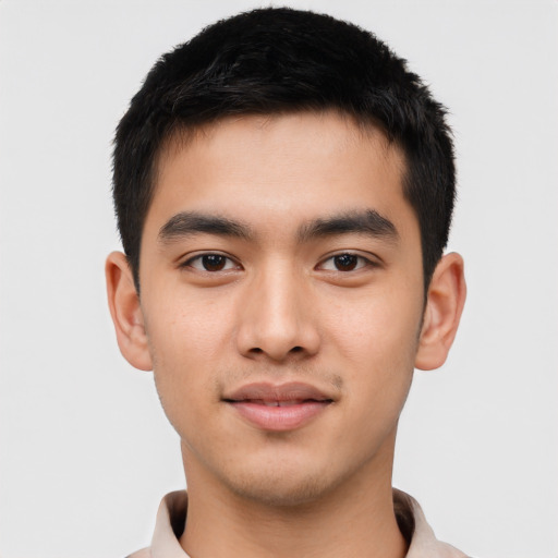 Joyful asian young-adult male with short  brown hair and brown eyes