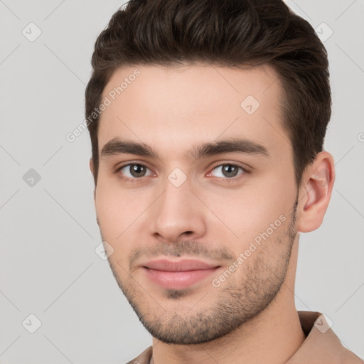 Joyful white young-adult male with short  brown hair and brown eyes