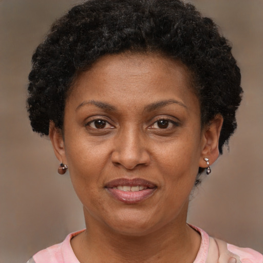 Joyful black adult female with short  brown hair and brown eyes