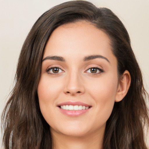 Joyful white young-adult female with long  brown hair and brown eyes