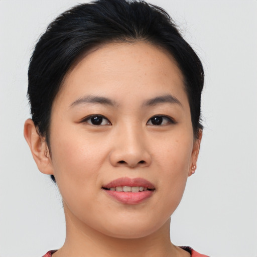 Joyful asian young-adult female with short  brown hair and brown eyes