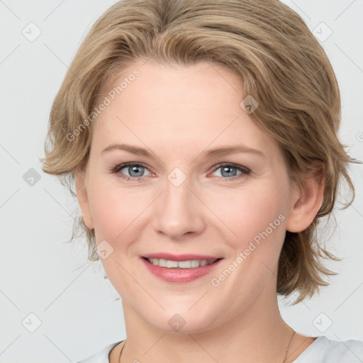 Joyful white young-adult female with medium  brown hair and blue eyes