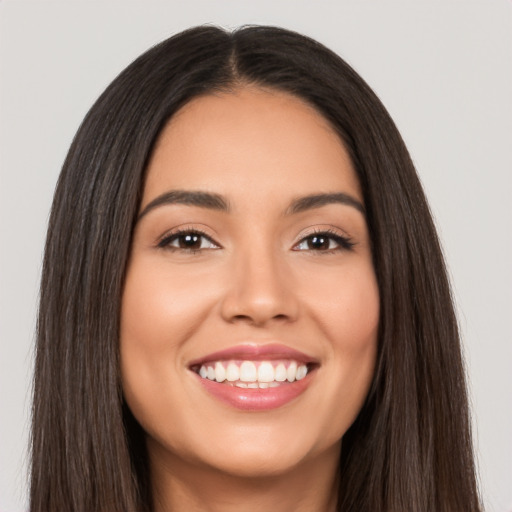 Joyful white young-adult female with long  brown hair and brown eyes