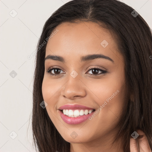 Joyful white young-adult female with long  brown hair and brown eyes