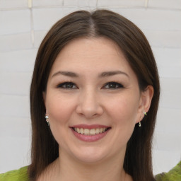 Joyful white young-adult female with medium  brown hair and brown eyes