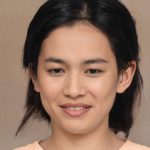 Joyful asian young-adult female with medium  brown hair and brown eyes