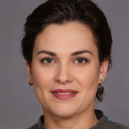 Joyful white adult female with medium  brown hair and brown eyes