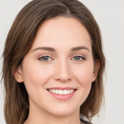 Joyful white young-adult female with medium  brown hair and green eyes