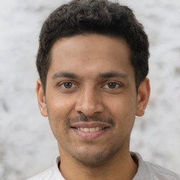 Joyful latino young-adult male with short  brown hair and brown eyes