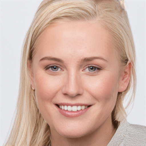 Joyful white young-adult female with long  brown hair and blue eyes