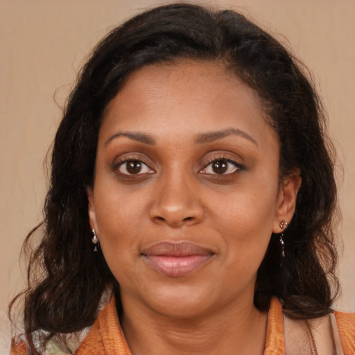 Joyful latino adult female with medium  brown hair and brown eyes