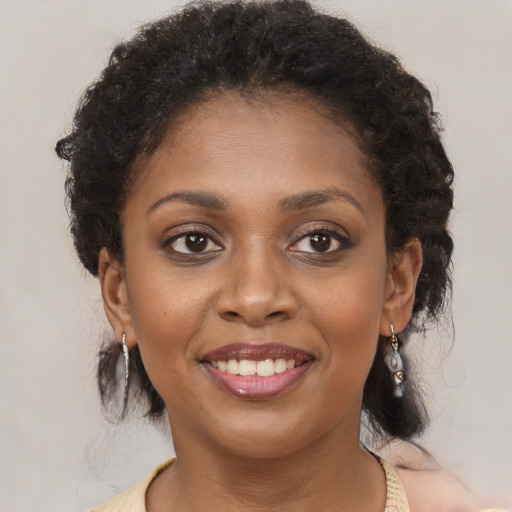 Joyful black young-adult female with medium  brown hair and brown eyes
