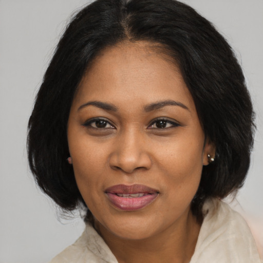 Joyful black adult female with medium  black hair and brown eyes