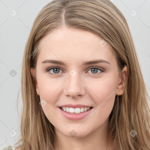 Joyful white young-adult female with long  brown hair and grey eyes