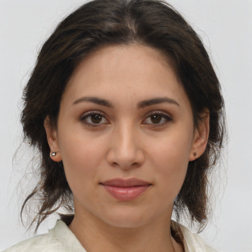 Joyful latino young-adult female with medium  brown hair and brown eyes