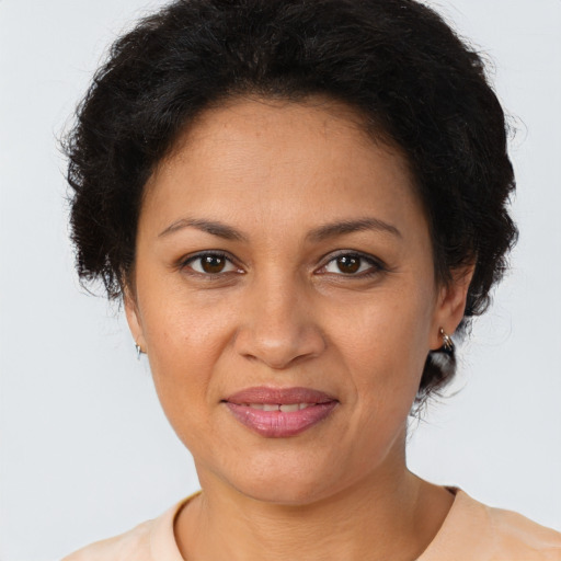 Joyful latino adult female with short  brown hair and brown eyes