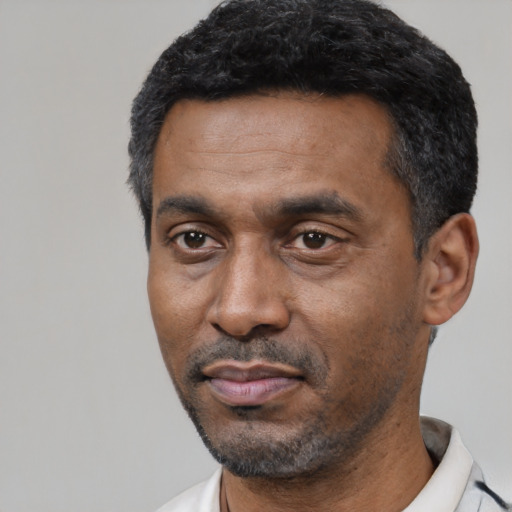 Neutral latino adult male with short  black hair and brown eyes
