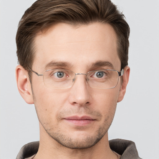 Joyful white adult male with short  brown hair and grey eyes