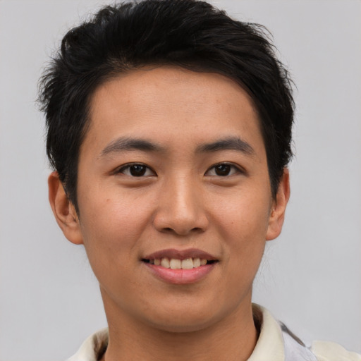 Joyful asian young-adult male with short  brown hair and brown eyes