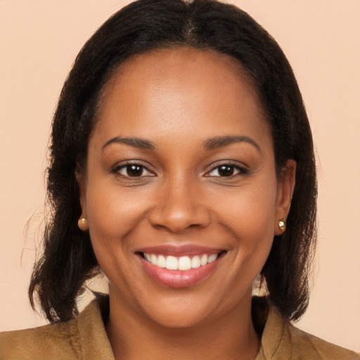 Joyful black young-adult female with long  brown hair and brown eyes