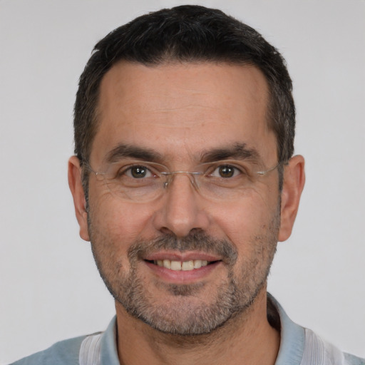 Joyful white adult male with short  brown hair and brown eyes