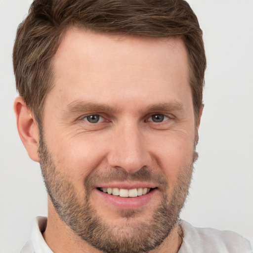 Joyful white young-adult male with short  brown hair and brown eyes