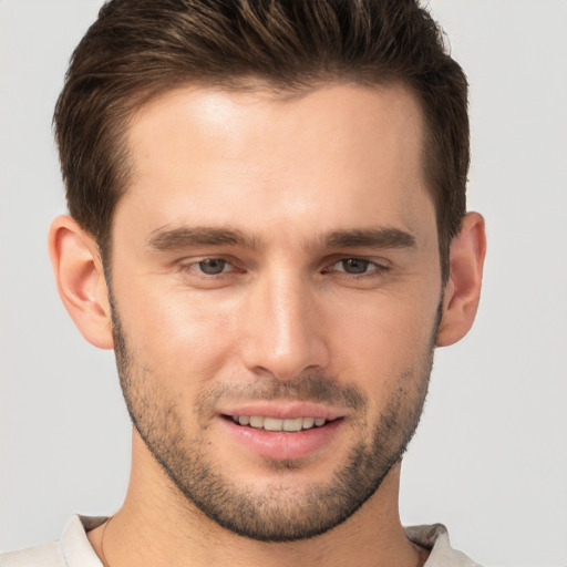 Joyful white young-adult male with short  brown hair and brown eyes