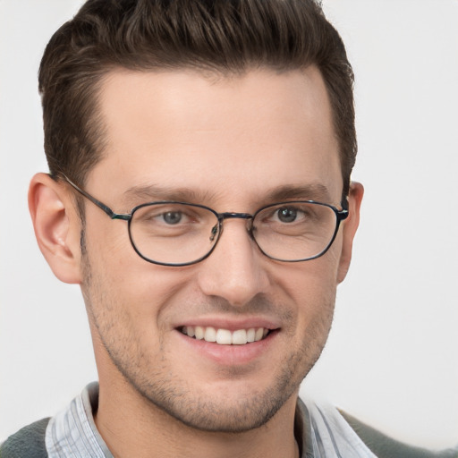 Joyful white young-adult male with short  brown hair and grey eyes