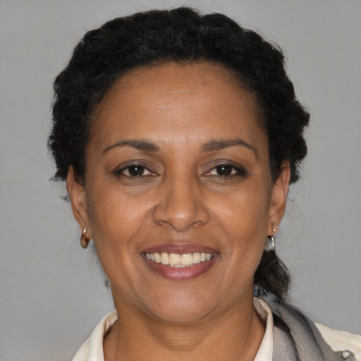 Joyful latino adult female with short  brown hair and brown eyes