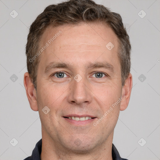 Joyful white adult male with short  brown hair and grey eyes